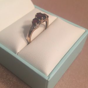 Three garnet stone and gold band ring